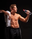 Shirtless sportsman taking rest and drinking water after workout Royalty Free Stock Photo