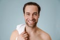 Shirtless white man smiling at camera while posing with towel Royalty Free Stock Photo