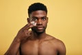 Shirtless young brutal african american man applying facial cream Royalty Free Stock Photo