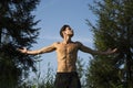 Shirtless young man celebrating nature