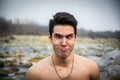 Shirtless young man outdoor doing silly face Royalty Free Stock Photo