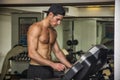 Shirtless young man running on treadmill in gym Royalty Free Stock Photo