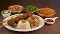 Shish kebab with mixed rice, kibbe and variety of ethnic lebanese food.