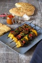 Shish kebab with pita bread ajvar and a garlic bulb Royalty Free Stock Photo