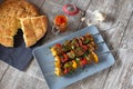Shish kebab with pita bread ajvar and a garlic bulb Royalty Free Stock Photo