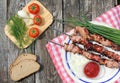 Shish kebab with vegetables on a wooden table. Royalty Free Stock Photo