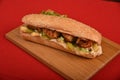 Shish taouk sandwich, traditional marinated chicken shish kebab of Middle Eastern cuisine. on wooden board & red background