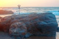 Shiva Face Rock Carving and Trident totem on Vagator Beach, Goa, India. Beautiful sunset background. Northernmost beach of Bardez Royalty Free Stock Photo