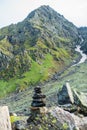 Shiva Linga made of rocks, a symbol of Lord Shiva in Hindu Mythology with Glacier mountains In the background. Shrikhand Mahadev Royalty Free Stock Photo