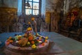 Shiva Lingam temple interior ornate with flowers and colors with majestic light coming from window, India. Architectural details o