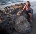 Shiva Rock Carving, North Goa, India. Young woman at Little Vagator Beach Royalty Free Stock Photo