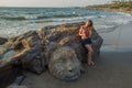 Shiva Rock Carving, North Goa, India. Young woman at Little Vagator Beach Royalty Free Stock Photo