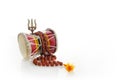 Shivaratri background with Shivas trident and Pellet Drum Damroo musical instrument . Hindu festival Maha Shivratri