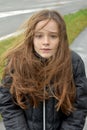 Shivering girl outside in stormy weather