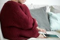 Shivering girl in warm knitted sweater sitting