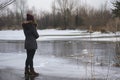 shivery stance, woman by frozen lake