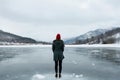 shivery stance, woman by frozen lake