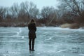 shivery stance, woman by frozen lake