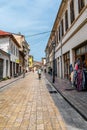 Tourist pedestrian Rruga G`juhadol street in Shkodra. Cyclists are riding and people are walkin