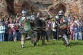 Reconstruction of the battle of medieval heavily armed foot soldiers