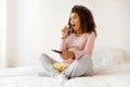 Shock Content. Black Pregnant Woman Watching Tv And Eating Popcorn At Home Royalty Free Stock Photo