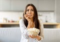 Shock Content. Scared Young Woman Watching Tv And Eating Popcorn At Home Royalty Free Stock Photo