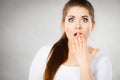 Shocked amazed woman covering mouth with hands