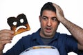 Shock man holds a burnt slice of toast Royalty Free Stock Photo