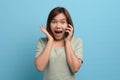 Shock / surprise and wow concept. Portrait of shocked asian woman looking in mobile phone and being surprised or astonished. Royalty Free Stock Photo