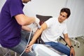 Shock wave therapy. Physiotherapist doctor uses medical equipment for highly effective epicondylitis, pain and inflammation treat
