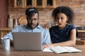 Stunned biracial couple shocked by email on laptop Royalty Free Stock Photo