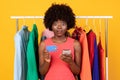 Shocked African American Woman Holds Phone And Credit Card, Studio Royalty Free Stock Photo