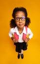 Shocked African School Girl Looking At Camera Standing Over Yellow Background Royalty Free Stock Photo