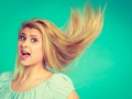 Shocked amazed blonde woman with crazy windblown hair