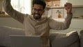 Shocked amazed Indian freelancer businessman astonish wonder excited Arabian guy happy man win laptop online bet job