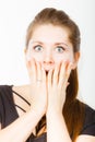 Shocked amazed woman covering mouth with hands