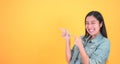 Shocked, amazed young beautiful asian woman 20s standing looking at camera with excited smile isolated on yellow background Royalty Free Stock Photo