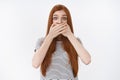 Shocked amused young redhead girl learn incredible rumor widen eyes raise eyebrows surprised cover mouth speechless