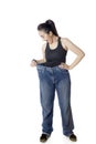 Shocked Arabian woman trying her old jeans Royalty Free Stock Photo