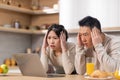 Shocked asian couple looking at laptop screen Royalty Free Stock Photo