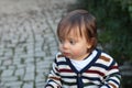 Shocked baby looking away outdoors