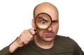 Shocked bald man looking through magnifying glass Royalty Free Stock Photo