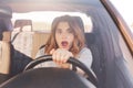 Shocked beautiful European female driver realzes that her car is brocken, can`t repair it by herself, sees awful accident on road, Royalty Free Stock Photo