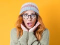 Shocked beautiful woman standing with positive surprised face expressing, isolated on yellow background. Crazy pretty girl