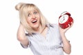 Shocked beautiful young woman with alarm clock