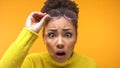 Shocked black female looking camera noticing first wrinkles, skin care, surprise Royalty Free Stock Photo