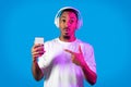 Shocked black guy pointing at smartphone in his hand Royalty Free Stock Photo