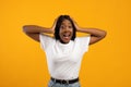 Shocked black lady in white t-shirt over yellow background Royalty Free Stock Photo