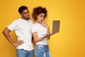 Shocked black millennial couple browsing on laptop Royalty Free Stock Photo