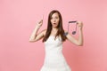 Shocked bride woman in wedding dress pointing index finger up hold musical note choosing staff musicians or DJ isolated